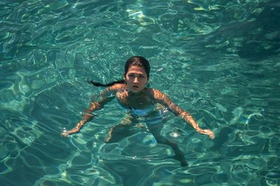 Portrait of happy girl in swimming pool