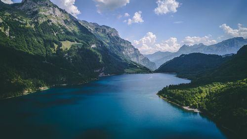 Scenic view of river amidst mountains against sky