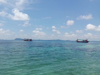 Boat sailing in sea against sky