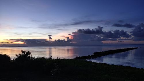 Scenic view of lake against sky at sunset