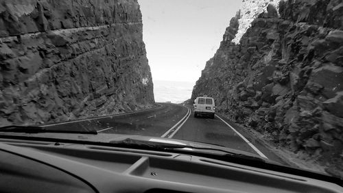 Empty road passing through tunnel