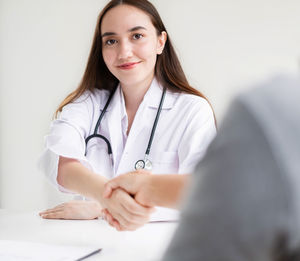 Portrait of female doctor examining patient