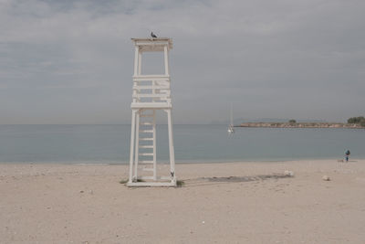 Lifeguard hut on beach against sky