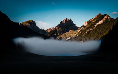 Scenic view of mountains against blue sky