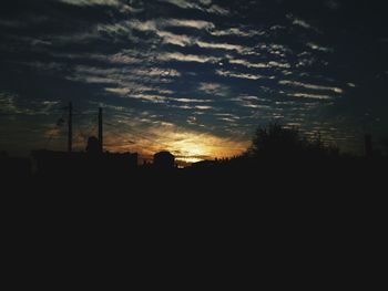 Silhouette landscape against sky at sunset