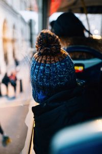 Rear view of woman sitting in bus during winter