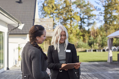 Estate agent talking to client