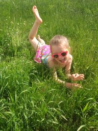 Cute girl playing on grassy field