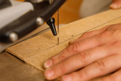 Cropped hands of man working at workshop