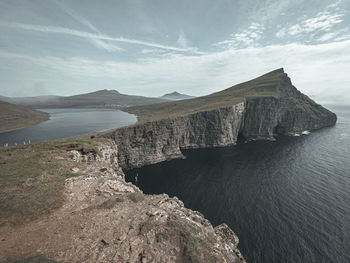 Scenic view of sea and mountains against sky