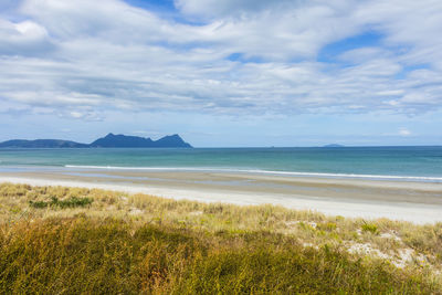 View of beach against cloudy sky
