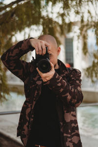 Portrait of man photographing with camera