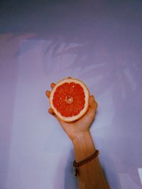 High angle view of woman holding orange