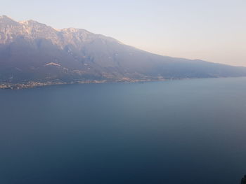 Scenic view of lake by mountains against sky