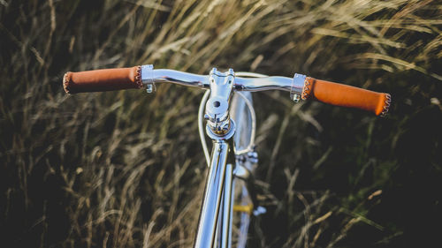 Bicycle on golden field against sky during sunset