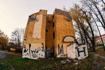 Graffiti on old building against clear sky