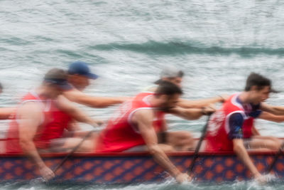 Blurred motion of people in boat