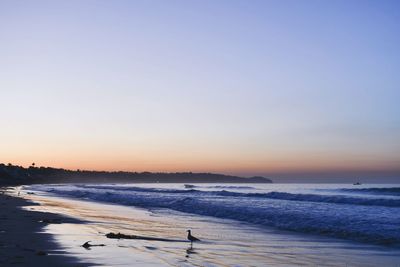 Scenic view of sea against clear sky during sunset