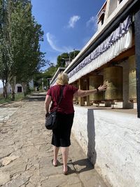 Full length rear view of woman walking on built structure