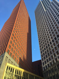 Low angle view of modern buildings against sky in city