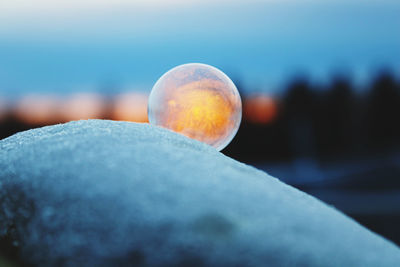 Close-up of rock against sky at sunset