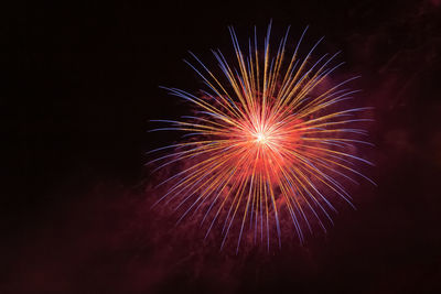 Low angle view of firework display at night