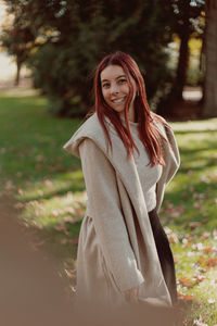 Portrait of smiling young woman standing outdoors