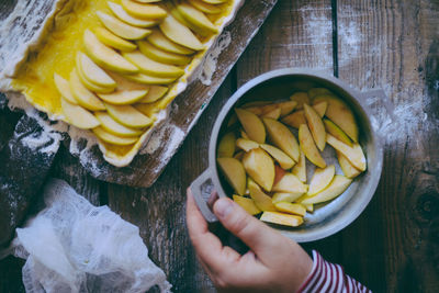 High angle view of hand holding fruit on table