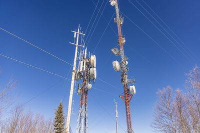 Low angle view of electricity pylon against sky