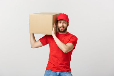 Portrait of young man standing against white background