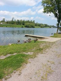 Scenic view of lake against cloudy sky