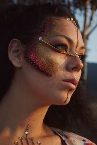 Close-up of woman with make-up looking away