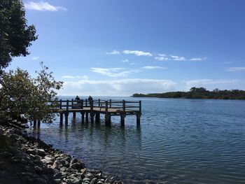 Pier over lake against sky