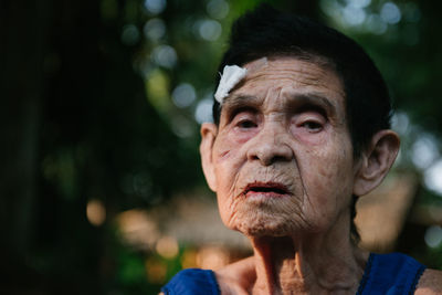 Portrait of woman against blurred background