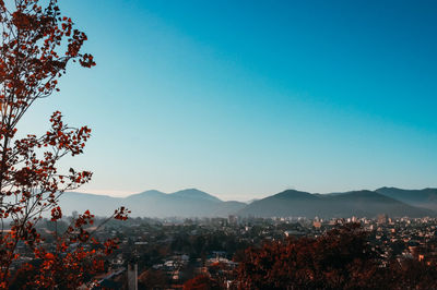 Aerial view of townscape against clear blue sky