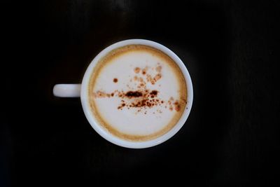 Close-up of coffee cup against black background