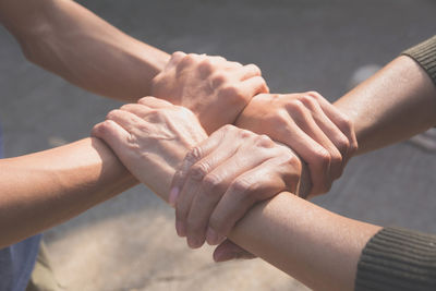 Cropped image of people hands forming chain