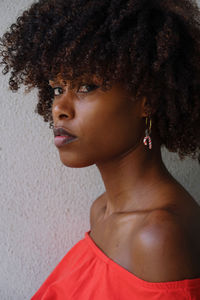 Portrait of a black woman with afro hair and christmas theme earring