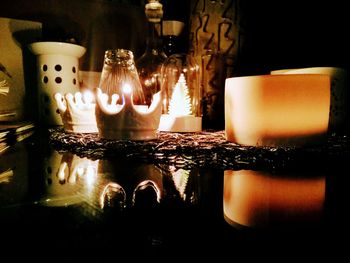 Close-up of illuminated candles on table