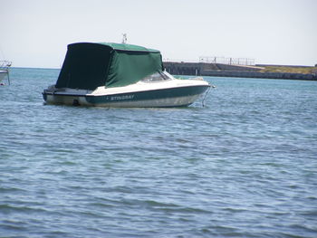 Boat moored on sea against sky