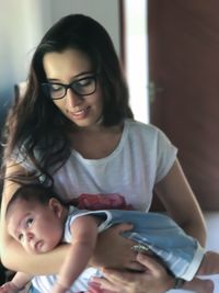 Close-up of happy mother holding baby girl