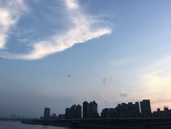 Silhouette buildings in city against sky