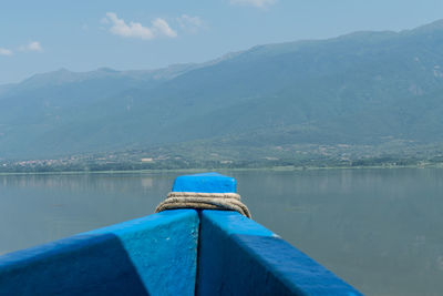 Scenic view of lake by mountains against sky