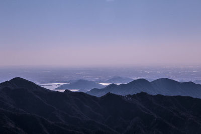 Scenic view of mountains against clear sky at dusk
