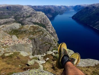 Low section of man on mountain against river