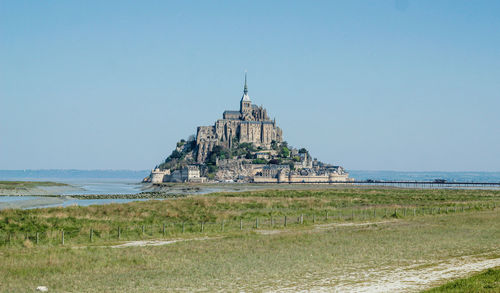 Scenic view of sea against clear blue sky