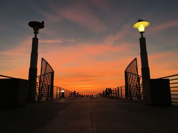 Silhouette bridge against sky during sunset