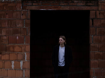 Man standing at doorway of building