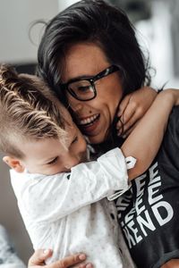 Smiling boy embracing mother