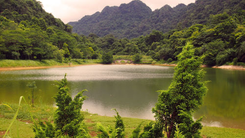 Scenic view of lake and mountains against sky
